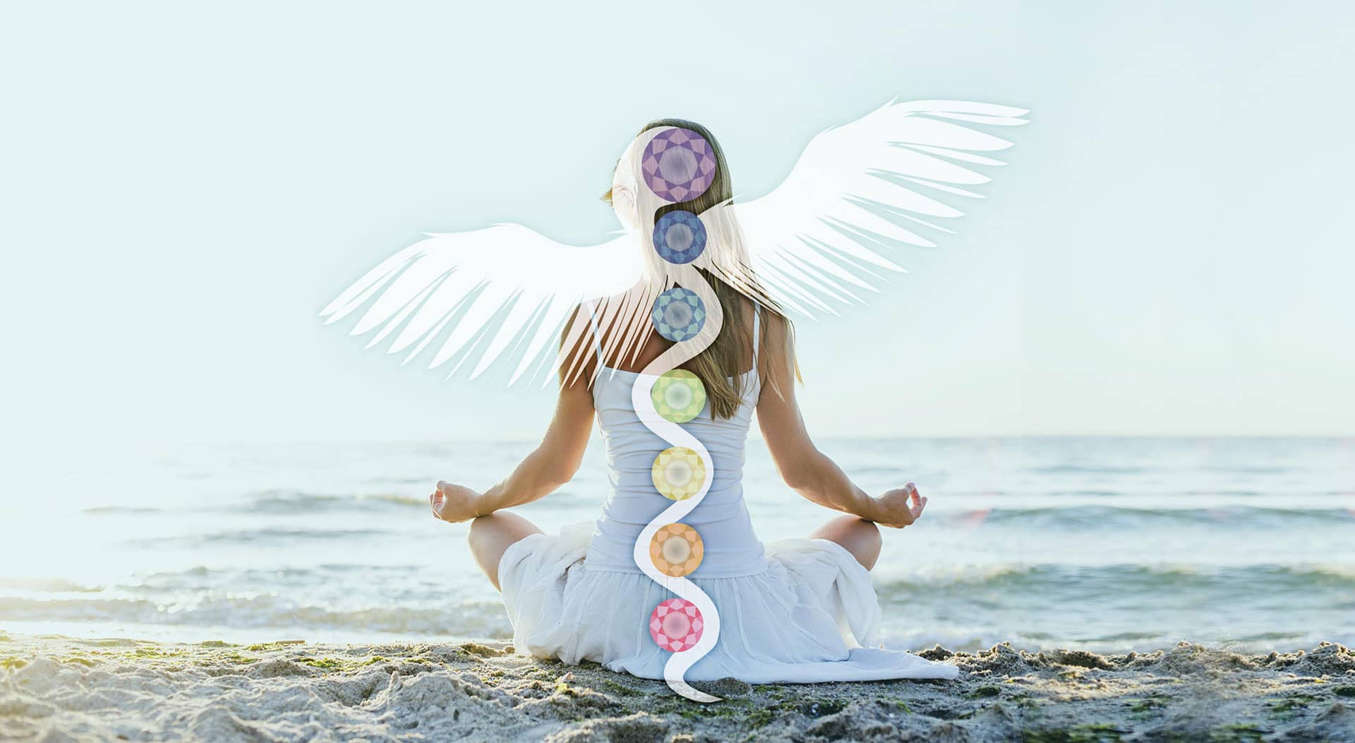 Woman sitting on the beach in front of the ocean