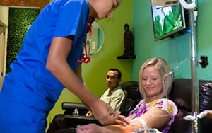 Patient receiving intravenous treatment by a nurse at Holistic Bio Spa cancer clinic in Mexico
